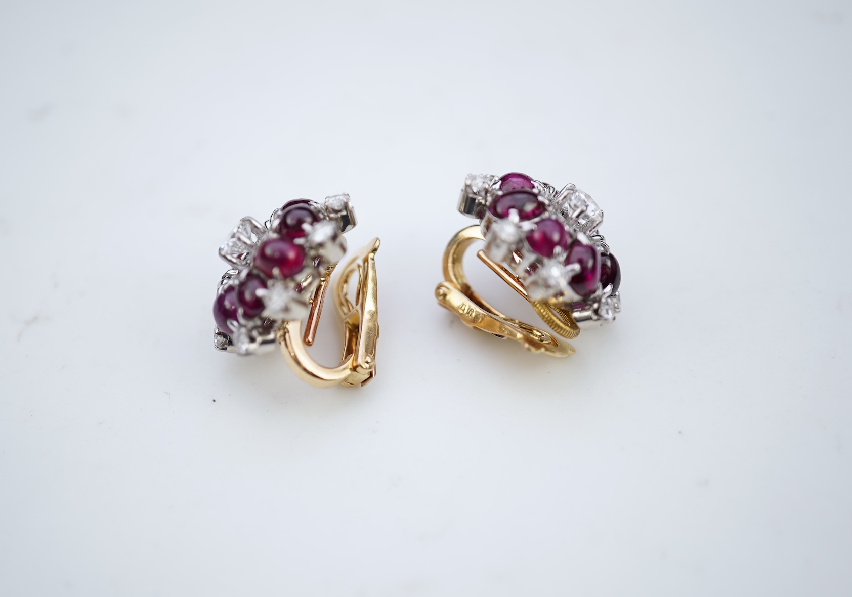 A pair of ruby and diamond ear clips, mid 20th century